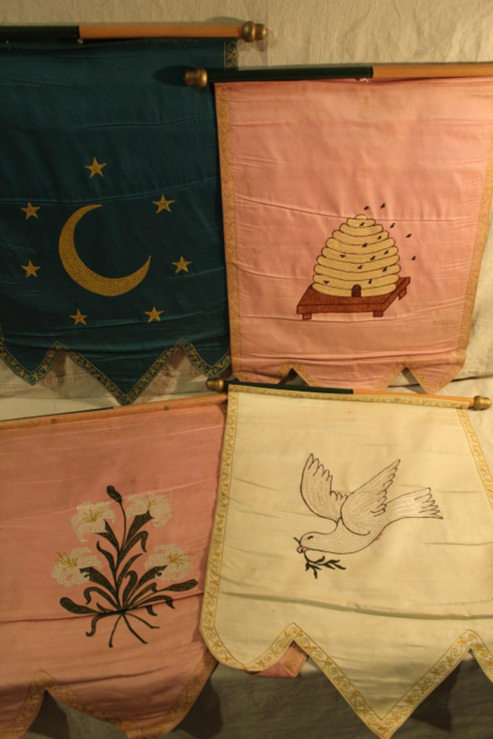 Odd Fellows Silk Embroidery Emblematic Banners: Group of four Early 20th Century Rebekahs cotton satine and machine embroidery emblematic banners with wooden acorn finials. In good vintage condition with some areas of dirt and staining. Dimension 2