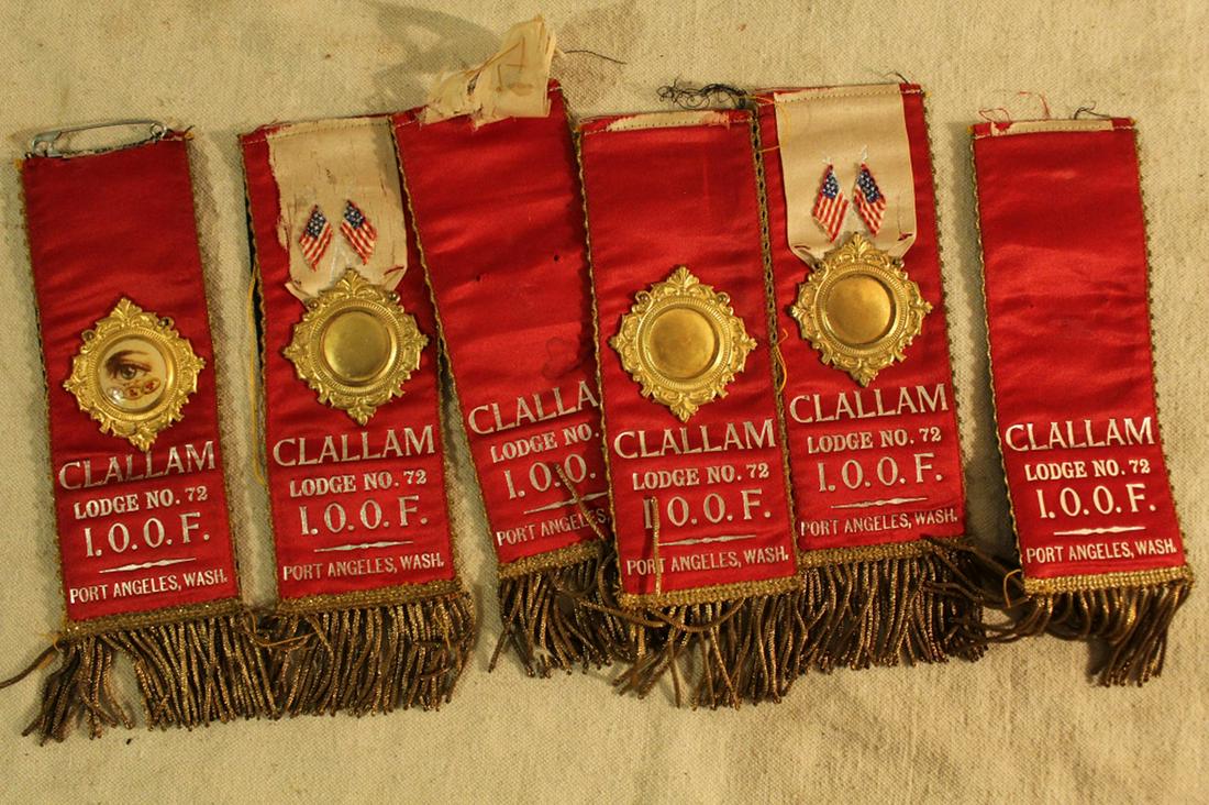 Lot Odd Fellows Silk Badges: Mixed lot of six reversible Odd Fellows silk badges from Clallam Lodge, Port Angeles WA. In good vintage condition with some pieces missing. Dimension 2 1/2"W x 9"L.