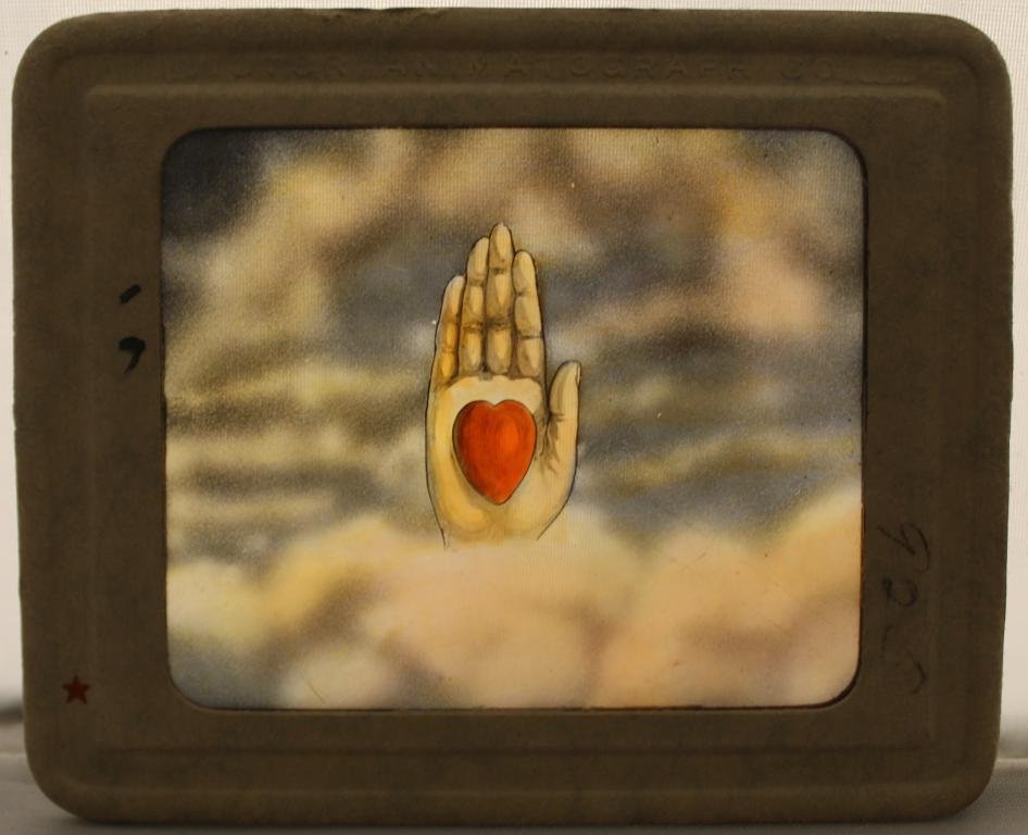 Antique Odd Fellows Magic Lantern Glass Slides: Group of 43 Odd Fellows hand colored glass slides in cardboard frames. Odd Fellows symbols, historical portraits, and bible scenes. Metal box stamped Victor Animatograph Co., Davenport, Iowa, U.S.A. A
