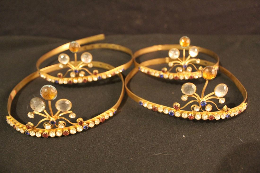 Antique Odd Fellows Rhinestone Tiaras: Group of four antique brass and glass jewel stone tiaras with adjustable bands and gold central stones. In good vintage condition; bands easily bend into shape. Dimension jeweled area 2 1/2"H x 7"W.