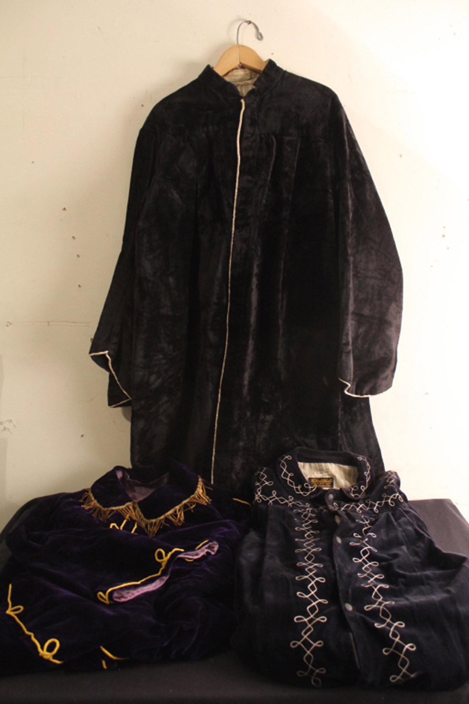 Group Velvet Odd Fellows Ceremonial Robes: Group of three Early 20th Century dark blue and purple velvet Odd Fellows ceremonial robes with contrasting machine embroidery. In good vintage condition. Sizes small/medium; floor length.