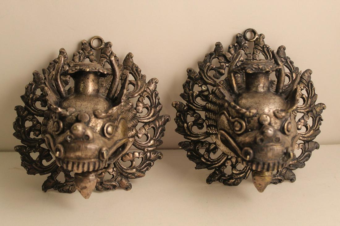 Tibetan Cast Metal Dragon Head Wall Candle Holders: Matched pair wall hanging candle holders. Well detailed castings with silver finish. 6.5" H x 6" W x 4.25" D approx.