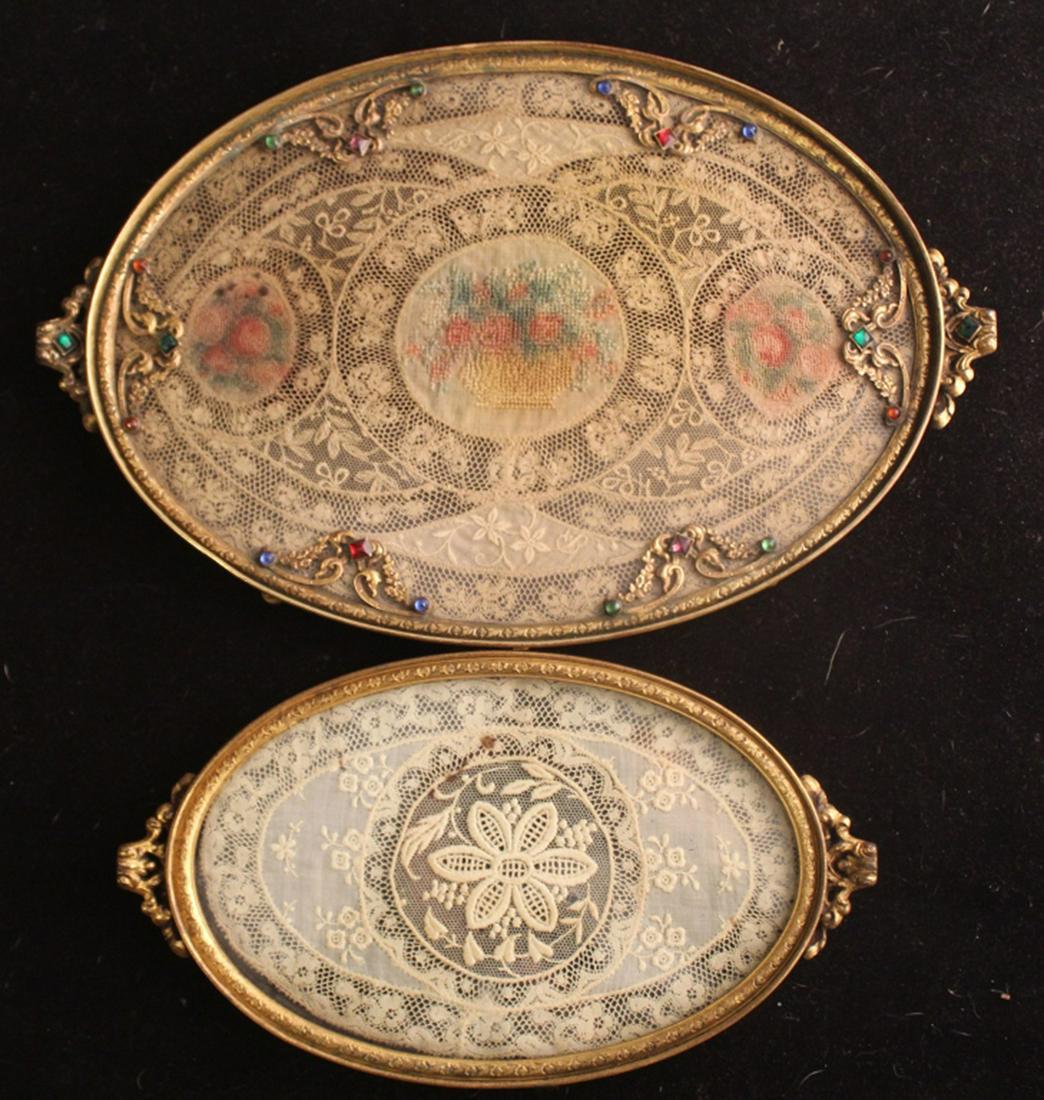 Apollo Studios Jeweled & Lace Vanity Trays: (1) Jeweled ormolu oval tray with hand made lace and petit point insert. Stamped APOLLO MADE IN U.S.A. 2752 11. Good condition; all jewels present, some age oxidation to frame, age toning/ slight spot