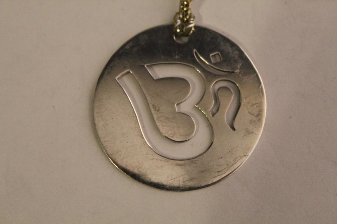 Sterling 925 Om Symbol Pendant Charm: Pierced lettering. Stamped I/K 925. Includes gold tassel. 6 grams approx. 1 3/8" dia.