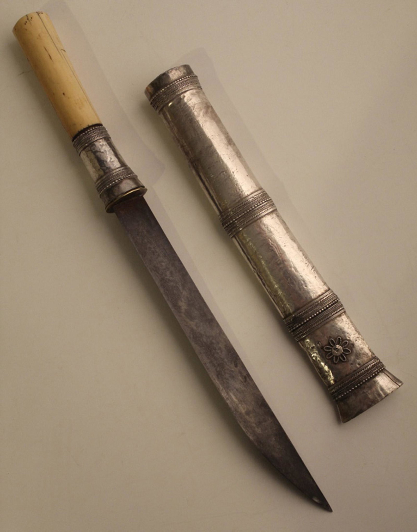 Antique Tibetan Dagger Knife w/ Scabbard: Bone and silver filigree handle with steel blade (signs of age with no major pits or breaks; sharp edge). Silver filigree over wood scabbard (very good condition with no large dents, damage, etc.). 12