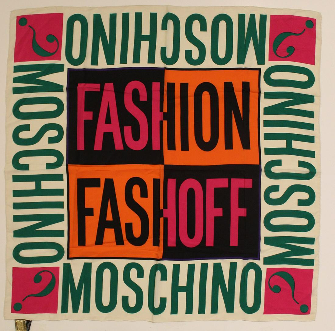 Maschino Silk Scarf: Vintage Moschino "FASHION FASHOFF" logo silk scarf. Hand rolled and stitched edges. Original Made in Itay labels. Very good condition; small pin hole near upper right corner. 32" x 32" approx.