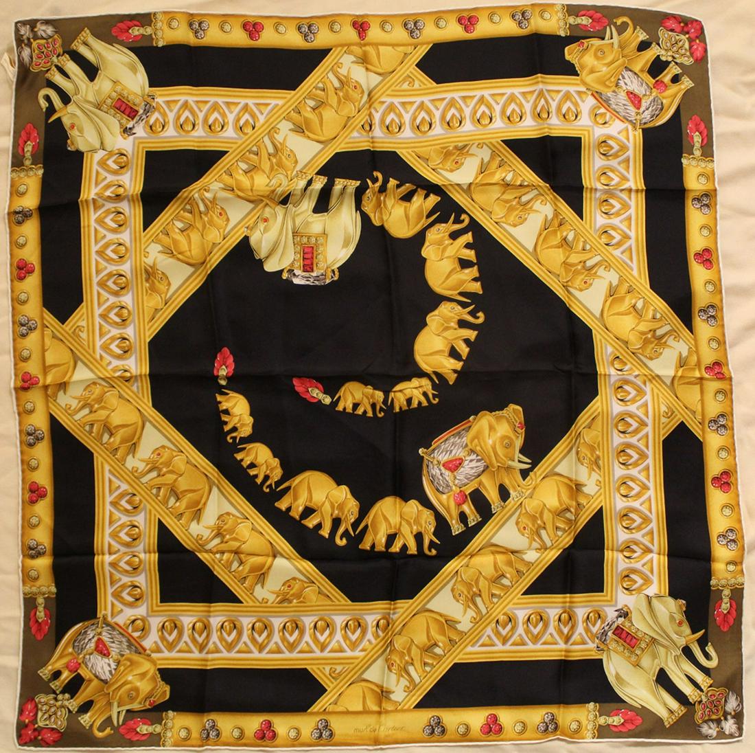 Must de Cartier Jeweled Elephant Silk Scarf: Vintage Must de Cartier silk scarf with jeweled elephant design. Hand rolled and stitched edges. Original Made in France label. Very good condition with bright colors. No apparent snags, pulls, damage