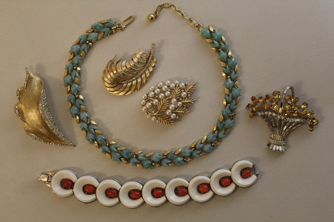 Collection Vintage Trifari Costume Jewelry: Includes: necklace with blue glass flowers (13" L approx.), bracelet with white and orange insets, basket form rhinestone pin (2 stones missing), pearl and leaf pin, rhinstone feather pin, and stylize