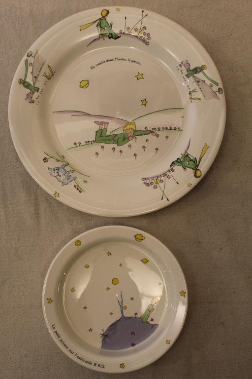 Le Petit Prince Gien France Plate & Bowl: (1) The Little Prince "Et, couche l'herbe, il pleura" plate. Marked to bottom with 1996 date. Excellnt condition with some light knife marks.10.75" dia. (2) The Little Prince "Le petit prince sur l'as