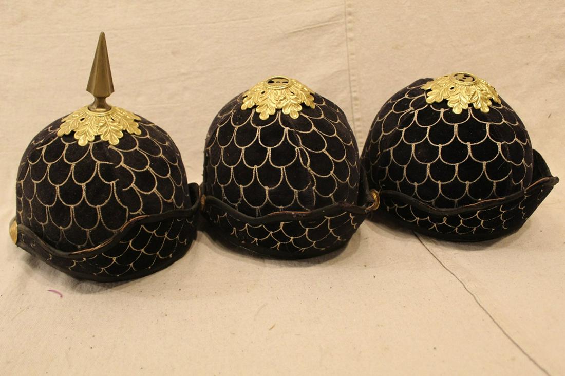 Group Spiked Blue Velvet Odd Fellows Helmets: Group of three navy blue velvet Odd Fellows helmets with brass spikes and white machine embroidery. In good vintage condition with two helmets missing spikes. Dimension largest helmet approximately 7"