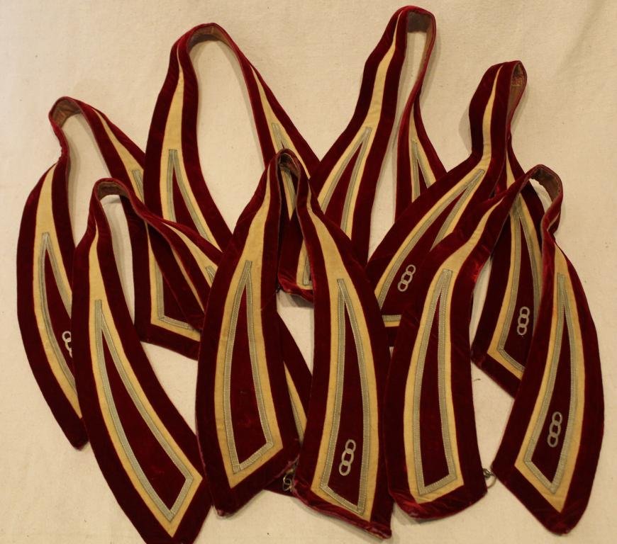 Group Odd Fellows Red Silk Velvet Collars: Group of seven Odd Fellows red and cream silk velvet member collars with triple link insignia. In good condition with some minor areas of wear to velvet pile, especially at tips, necks and edges. Dime