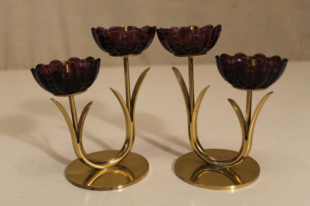 Mid Century Ystad Metall Sweden Candle Holders: Pair heavy brass double flower candle holders with amethyst glass "petals". Designed by Gunnar Ander. Impressed marks to bases. Excellent condition. 4 5/8" H.