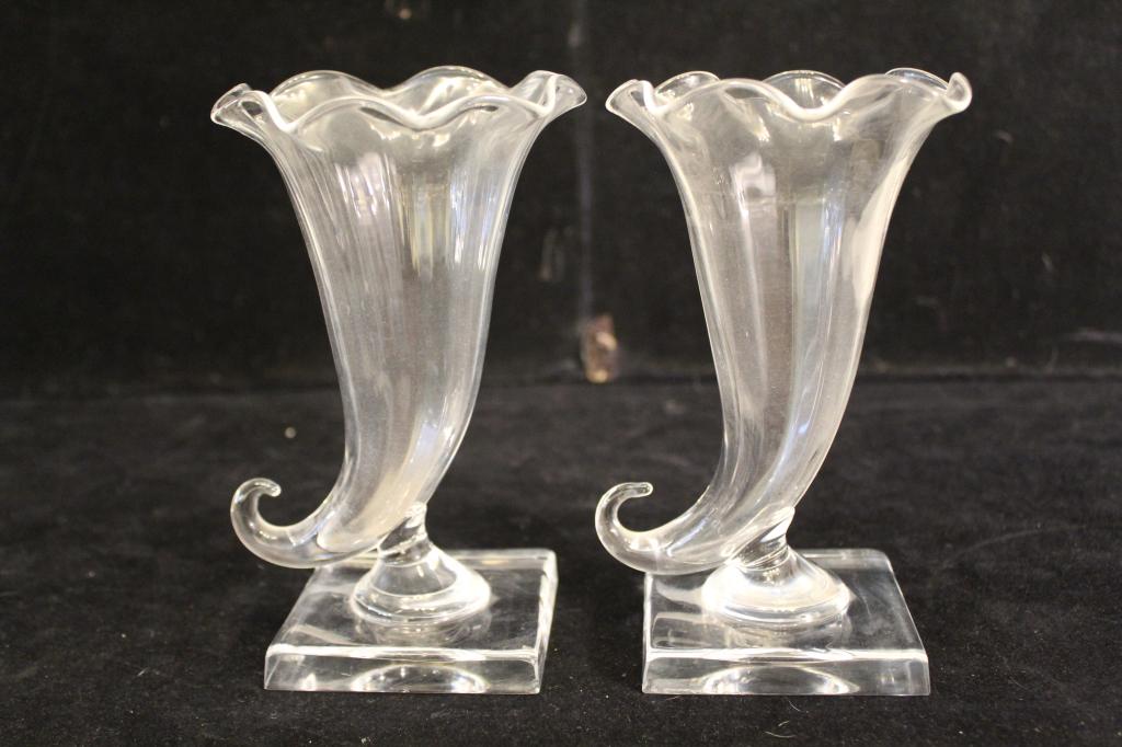Vintage Steuben Cornucopia Vases: Two Steuben cornucopia vases. One vase with small flea bite chip to base; one vase with two base corner chips. Etched Steuben signatures. Mid 20th C. 6.5" H approx.