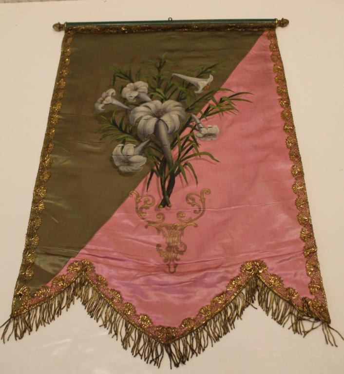 Antique Odd Fellows Silk Banner: Hand painted lilies on pink and green silk. Gold metal trim and fringe. Banner attached with tacks to wood rod (23") with brass finials. Good condition with signs of age, etc. 30" x 20.25".