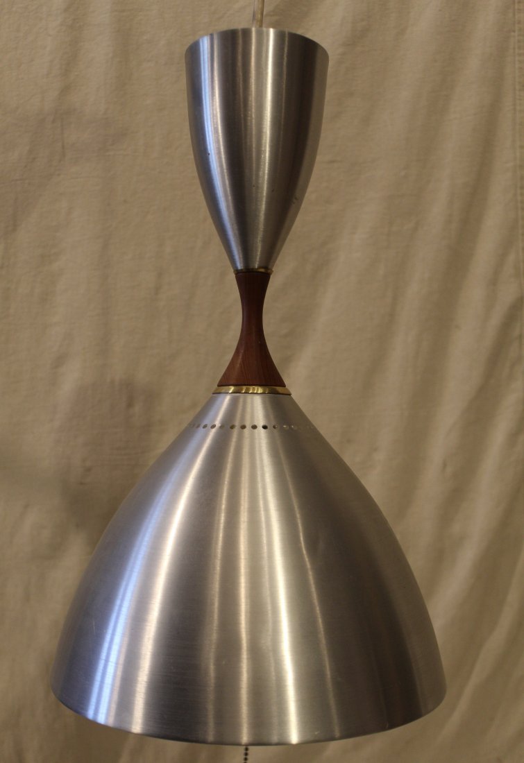 Mid Century Aluminum & Teak Pendant Light: Brushed aluminum top and bottom shades with teak connecting section. Lower shade with single socket; upper shade with two candle bulb uplight sockets. Good condition with a few small shallow dents to 