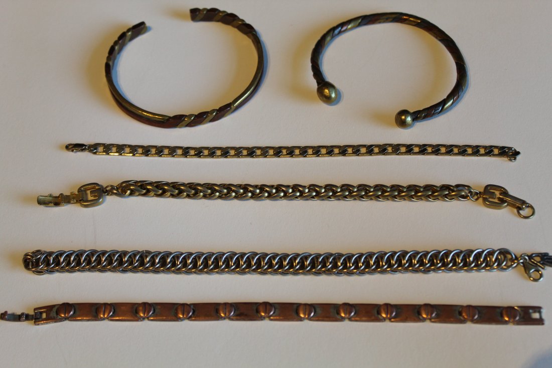 Collection of Metalwork & Chain Bracelets: (1) Two brass and copper hand made cuff bracelets. (2) Gold filled double chain bracelet with hand charm, 8.5" L approx. (3) Gold tone flat chain bracelet, 8.25" L. (4) Gold tone round chain bracelet,