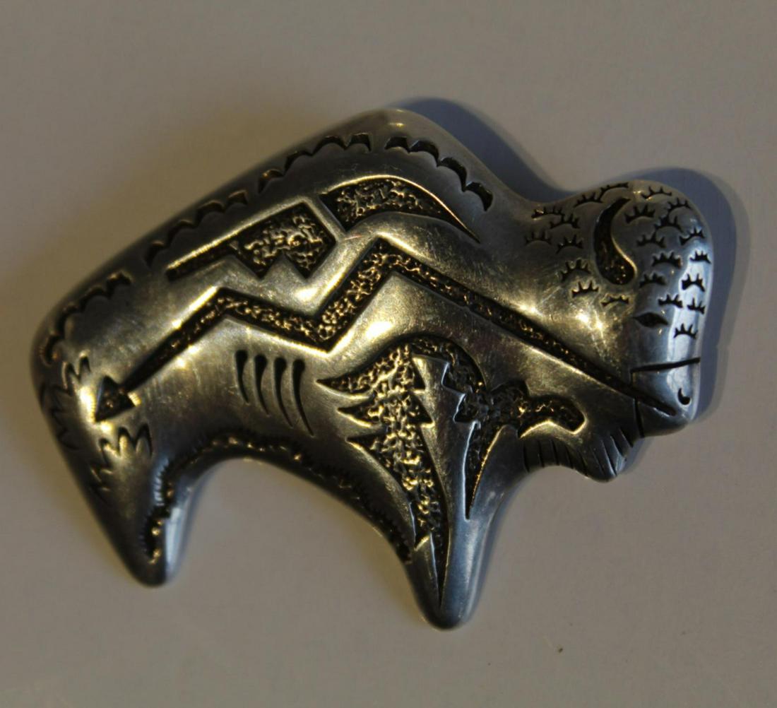 Tommy Singer Sterling Buffalo Pendant Brooch: Marked T. Singer and 925. Clasp pin and pendant loop. 13 grams approx. 1 3/8" x 1 3/4" approx.