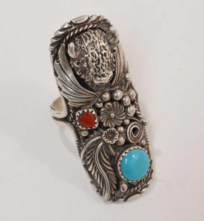 Navajo Sterling & Turquoise Ring by Running Bear: Buffalo design inset with turquoise and carnelian stones. Stamped RB STERLING and engraved Yellowhorse #533. 1 7/8" L approx.14 total grams approx.