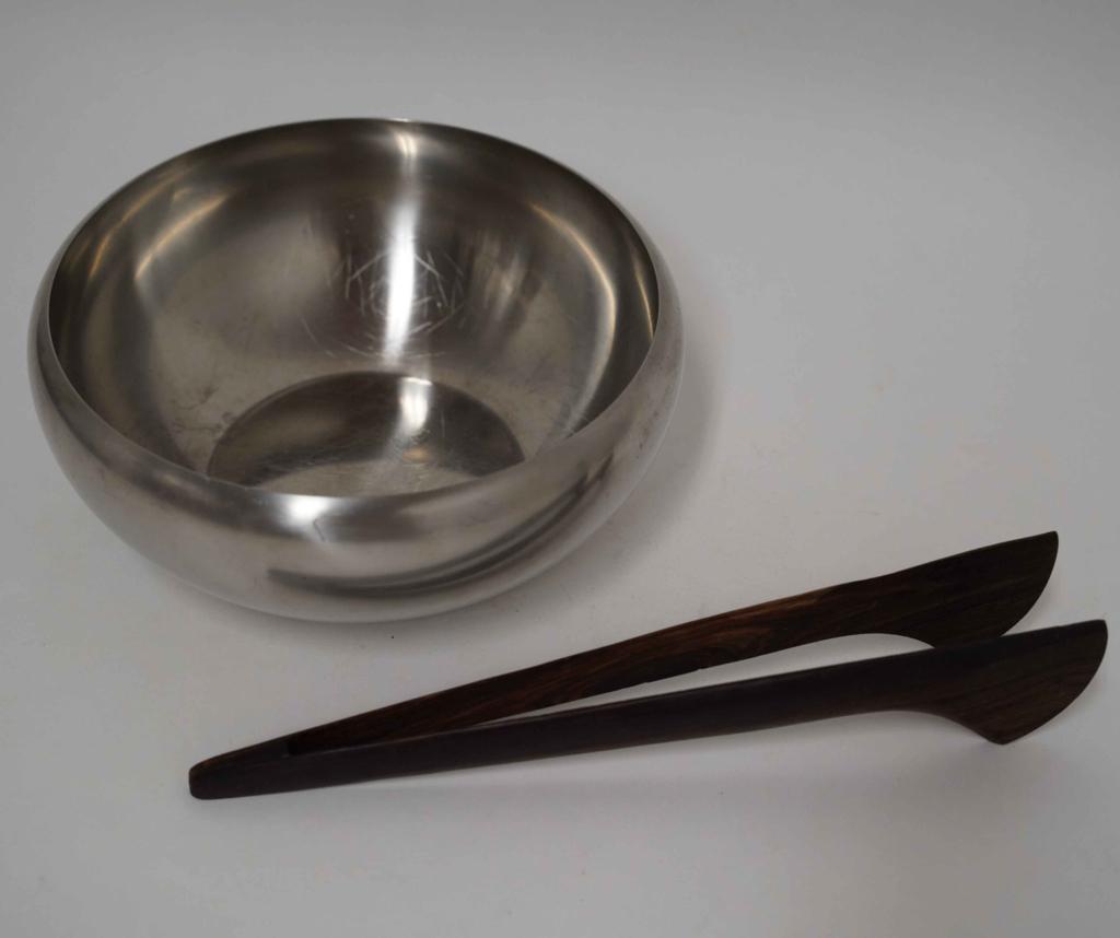 Carlo Mazzeri Alessi Salad Bowl / Rosewood Tongs: (1) Stainless steel large bowl designed by Carlo Mazzeri for Alessi Italy. Good condition; signs of normal use, no dents or deep scratches. Marked to bottom. 4" H x 10" dia. approx. (2) Mid century un