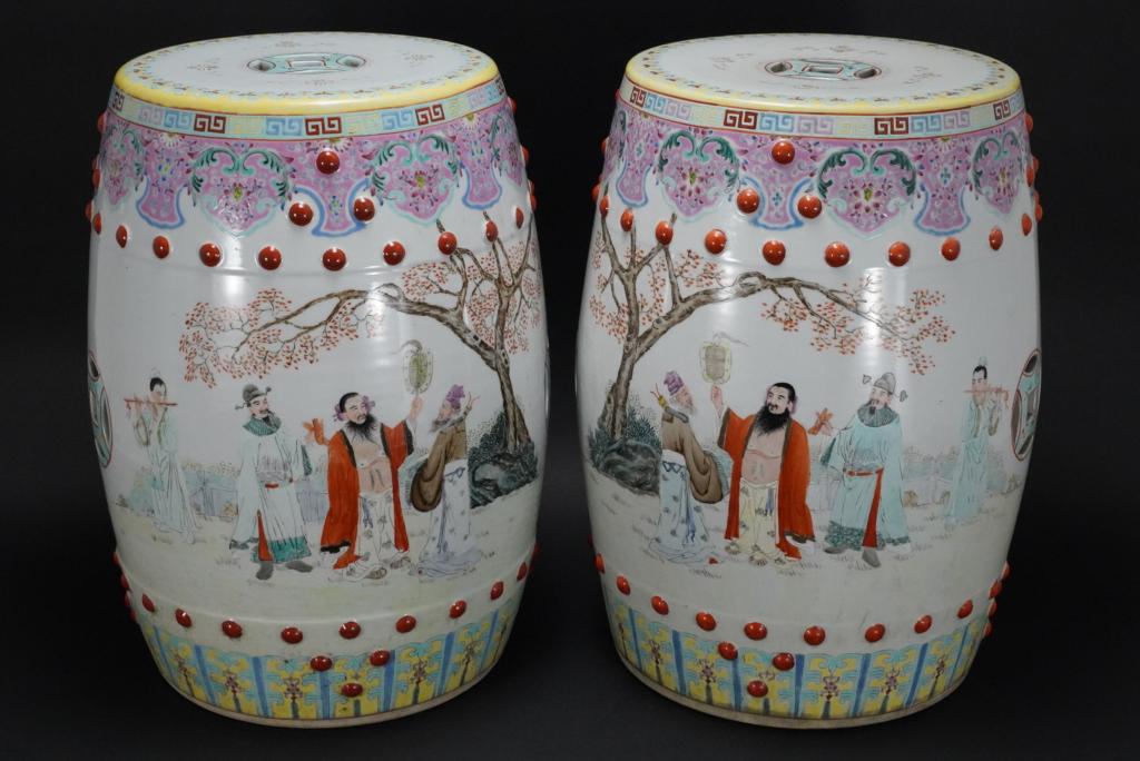 Pair Chinese Famille Rose Garden Stools: Matched pair in barrel form with piercing to tops and sides. Hand painted mirror matched figural garden scenes to each side. Floral decortative borders. Impressed markings to bottoms of both. Excellen
