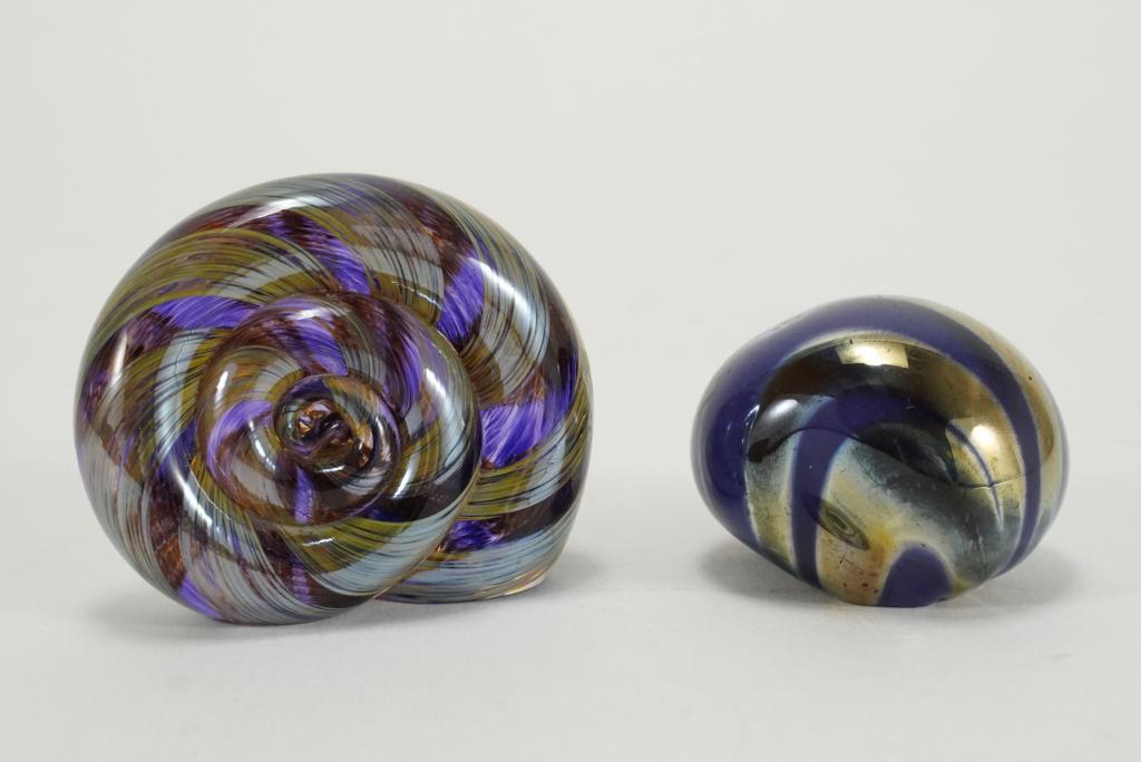 Studio Art Glass Sculpture Paperweights: Amethyst shell form with stripes and purple orb form with metallic swirls. No apparent signatures. Excellent condition. Shell 2.25" H x 2.75" W.