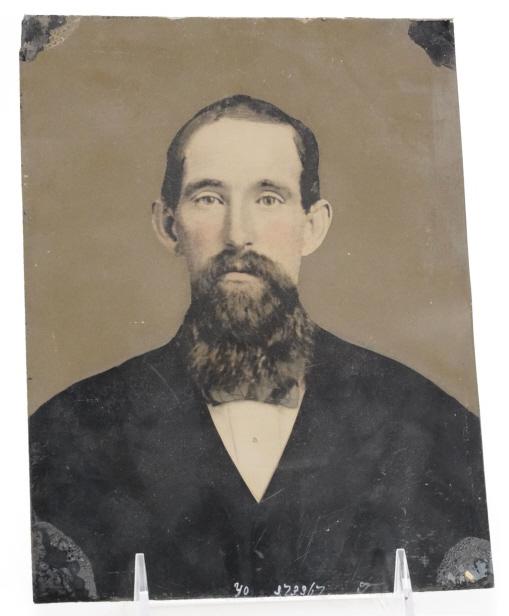 Antique Whole Plate Tintype Portrait of a Man: Bearded man with areas of hand tinting and paint. Photographer's notation numbers to bottom. Later added identifcation to the reverse: John Glover B. Nov. 4, 1836 D. Oct 6, 1884. Very good condition w