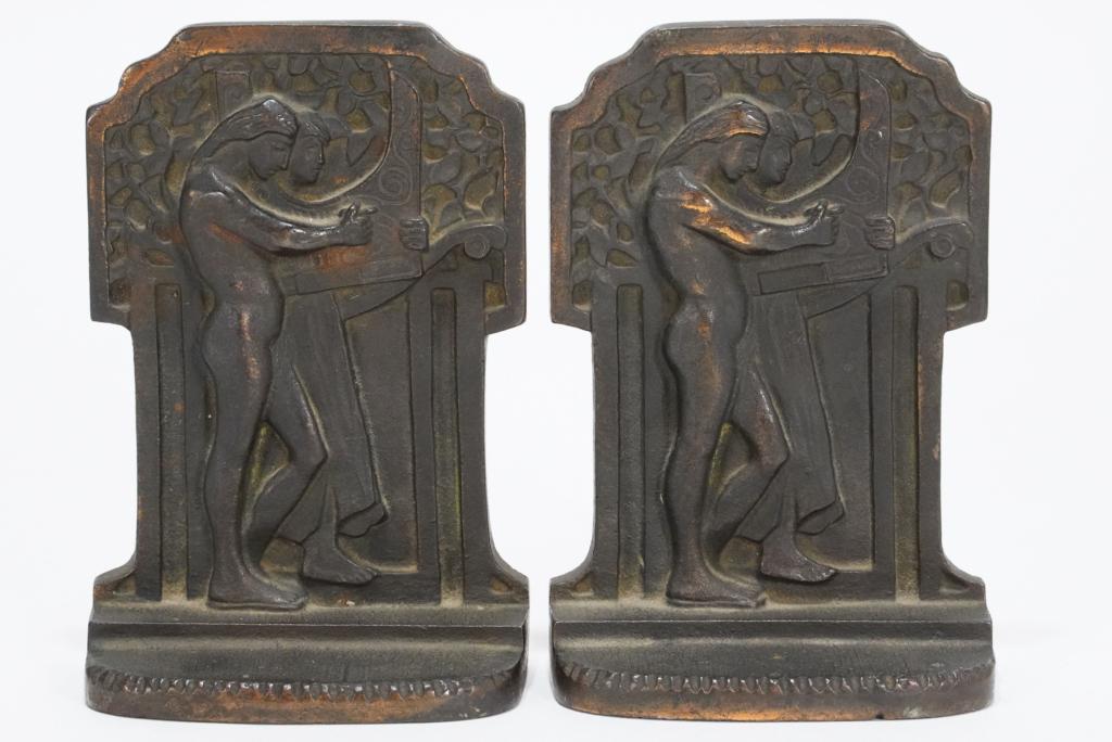 Vintage Cast Iron Bookends Male Nude: Raised relief male nude harp player. Stamped 298; no apparent maker's marks. Cast iron with copper plated surface. Good aged suface patina. Circa 1920's/ 30's. 5.75" H x 4" W x 2" D.
