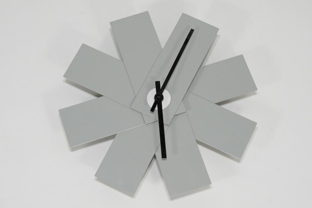 Normann Copenhagen Watch Me Wall Clock: Dove grey enamel on metal. Marked to back. Battery operated movement; working. Good condition; minor scuffs to minute hand. 11" x 11".