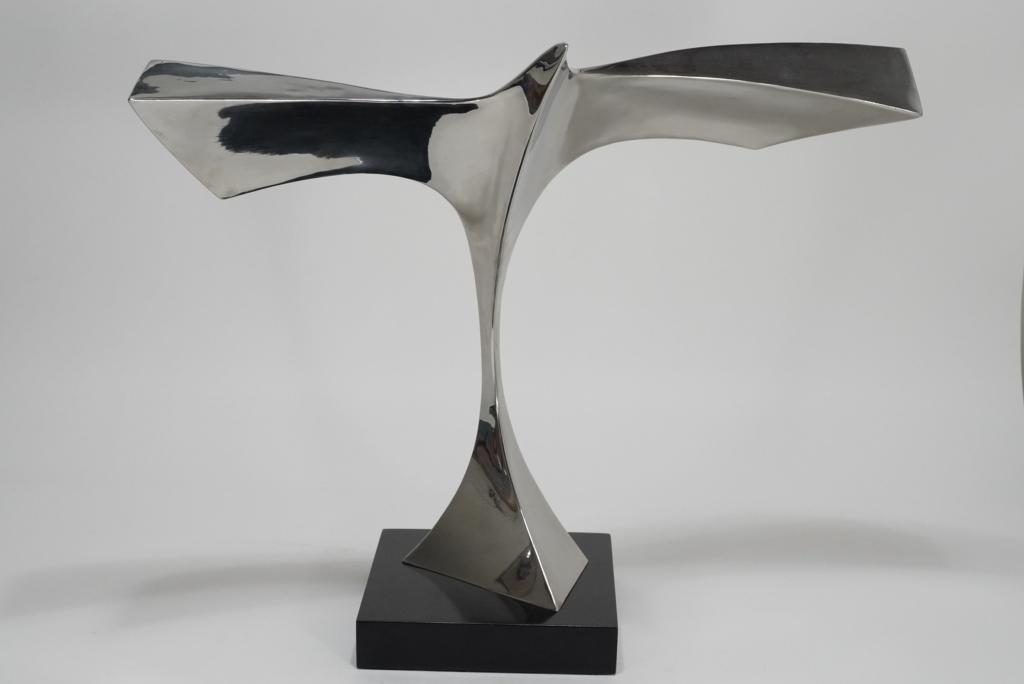 Hermann Wiemann (b.1928) Metal Sculpture: Polished stainless steel stylized modernist bird in flight. Signed H. WIEMANN and dated '77. Mounted to black lacquered wood base (9" x 9" x 1.75"). 20.75" (total height) x 25" W approx.