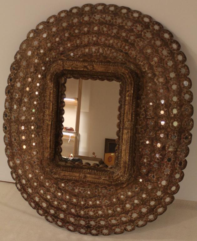 Large Vintage Indian Peacock Wall Mirror: Hand constructed and carved solid wood 'peacock" curved frame surrounding a center frame with mirror. Glaze painted and gilded surface inset with miniature round mirrors. Excellent original condition.