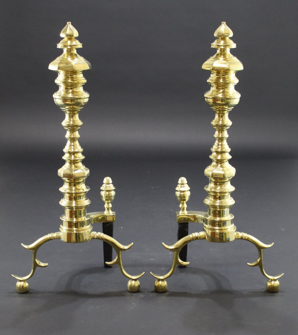 Pair Virginia Metalcrafters Brass Andirons: Solid cast brass with single piece posts. Virginia Metalcrafters logo marks. Excellent like new condition with no signs of use. 24" H x 12" W x 8" D each approx. 16 lbs. each approx.