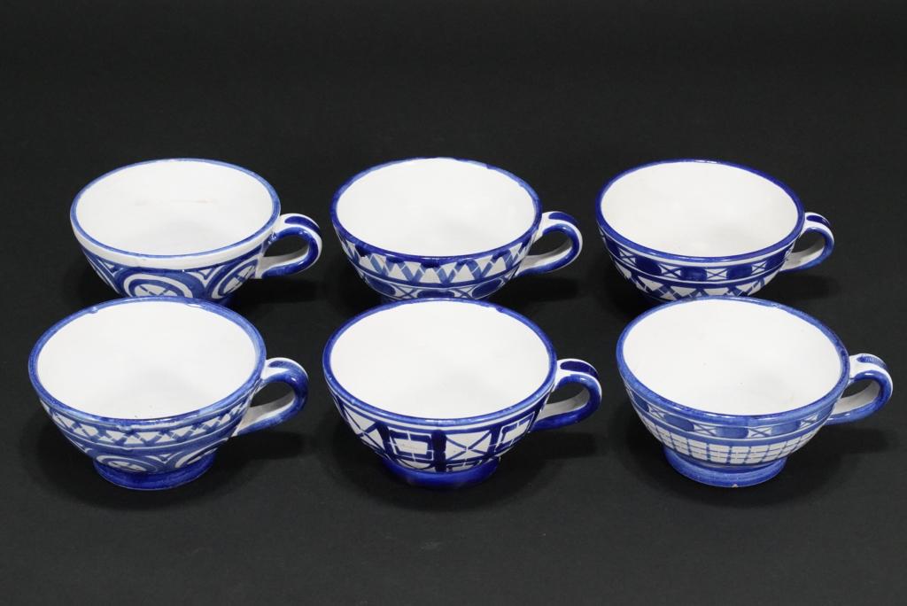 Robert Picault France Pottery Cups: Set of 6 handled cups each with different designs in blue glaze. All signed RP FRANCE. Good condition; three cups with light stains to interiors. Three with minor small glaze flakes at base edges. 2.7