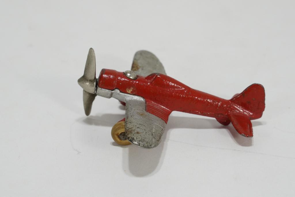 1930s Hubley Cast Iron #2226 Airplane: Red and silver painted toy airplane with nickel plated propellor and white rubber wheels. Marked HUBLEY U.S.A. 2226 to wing; marked 2226 10 to body portion. Appears in all original condition with norm