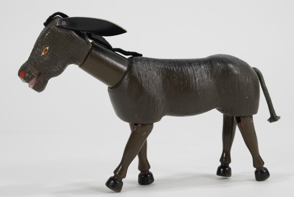 Schoenhut Humpty Dumpty Circus Toy Donkey: "The Humpty Dumpty Circus" articulated toy donkey figure. Appears in very good original condition with painted eyes, leather ears, cord tail, and felt mane. 6" H x 8" L approx.