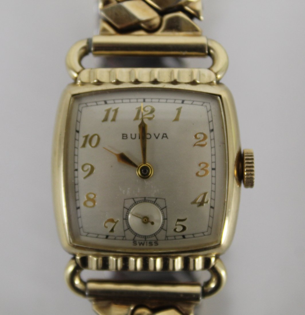 Vintage Bulova Gold Filled Mens Watch: Gold filled watch with second hand dial. Stainless steel back marked BULOVA A9 2270695. Winding stem marked BULOVA. Stretch link band marked BULOVA 1/20 12K G.F. TOP. Excellent cosmetic condition; "cl