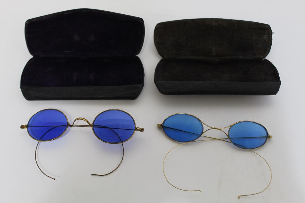 Antique Cobalt Blue Lens 14K Gold Glasses: (1) Blue lens glasses with marked 14K gold wire frame. Lenses 1" x 1 5/8" each approx. (2) Blue lens glass with probably gold filled wire frames. Lenses 1 1/4" x 1 5/8" each approx. Both in good condi