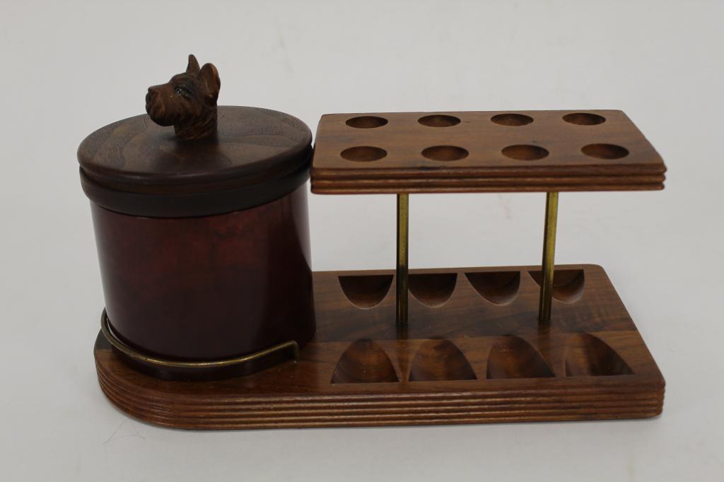 Scottie Dog Humidor & Pipe Rack: Heavy plastic / bakelite faux tortoise jar. Walnut lid with hand carved wood Scottie dog finial handle (one glass eye missing). Stand in solid walnut. Decatur Industries Inc. label to the underside. E