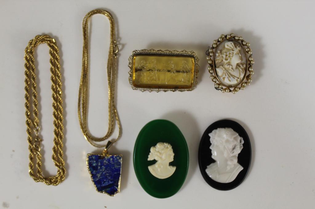 Cameo Brooch Pins / Costume Jewelry: (1) Three cast cameo pins; one in gold tone metal / faux pearl setting. Largest (signed Crawford"), 2" x 1 3/8". (2) Glass intaglio pin in gold tone metal setting. (3) Monet twist chain necklace, 16".