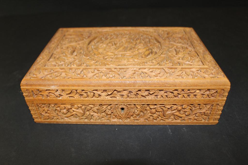 Vintage Anglo Indian Carved Sandalwood Box: Intricately and finely carved to all sides. Lid carved with center medallion depicting a woman, two demon type figures, and a tiger/ panther. Slight lifting to lid panel and small nick / chip to back 