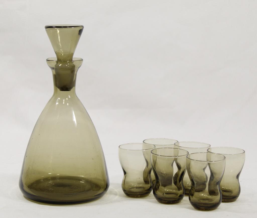 Mid Century Scandinavian Glass Decanter & Glasses: Smoke amber glass decanter with 6 matching cordial / shot glasses. Mid 20th C. Very good condition. Decanter 8" H (including stopper) x 4 1/4" dia. Glasses 2 1/4" H x 1 3/4" dia.