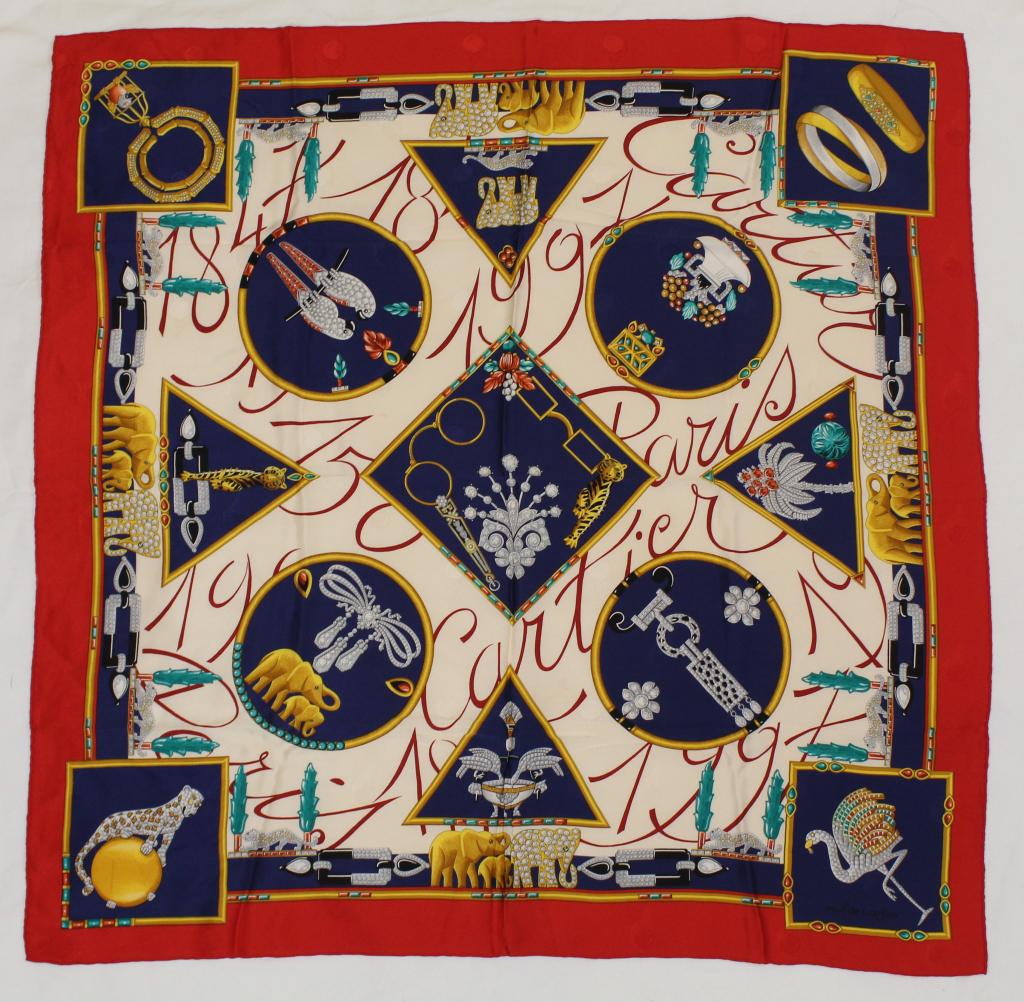 Cartier Paris Silk Scarf: Jeweled animal brooch design on jacquard woven silk. Hand rolled and stitched edges. Small light brown spot left lower bottom edge, small pale pink spot to field, pin hole and small pull upper left si