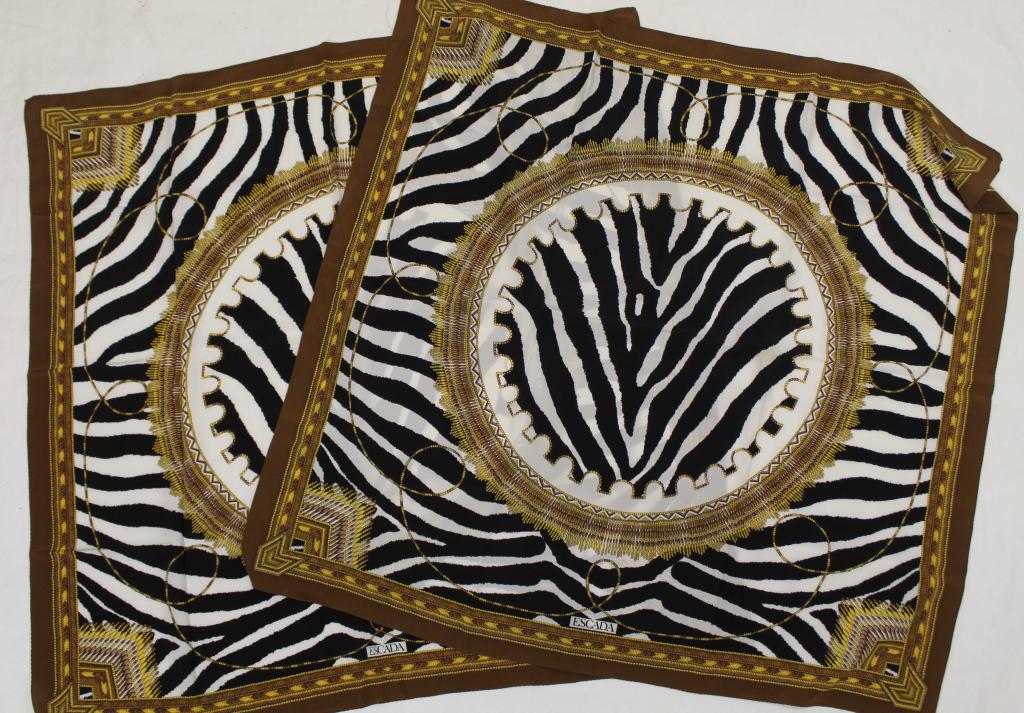 Pair Escada Zebra Stripe Scarves: Two matching zebra stripe design scarves with African "basket weave" motif borders. Rolled and stiched edges. Very good condition; one scarf with two small pin holes upper right corner. 33" x 34.5" ea