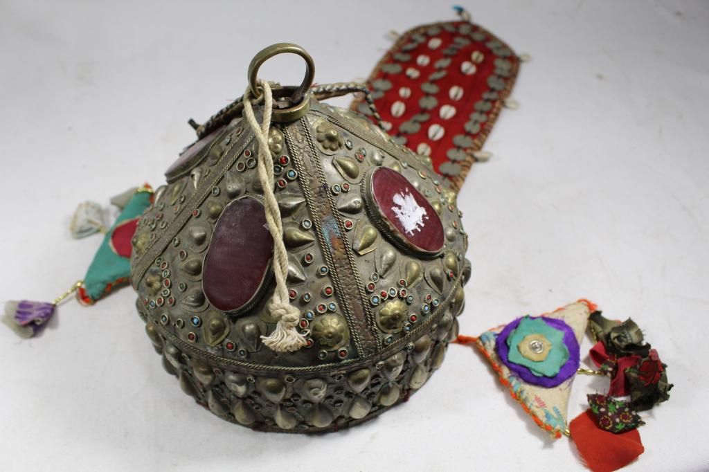 19th Century Afghani Metal Wedding Headdress: Hand hammered metal with carnelian oval panels and glass bead insets. Fabric panels (added later) with stamped metal disks and shells. Good condition. Metal portion circa late 19th C. 7.75" H x 7.25" 