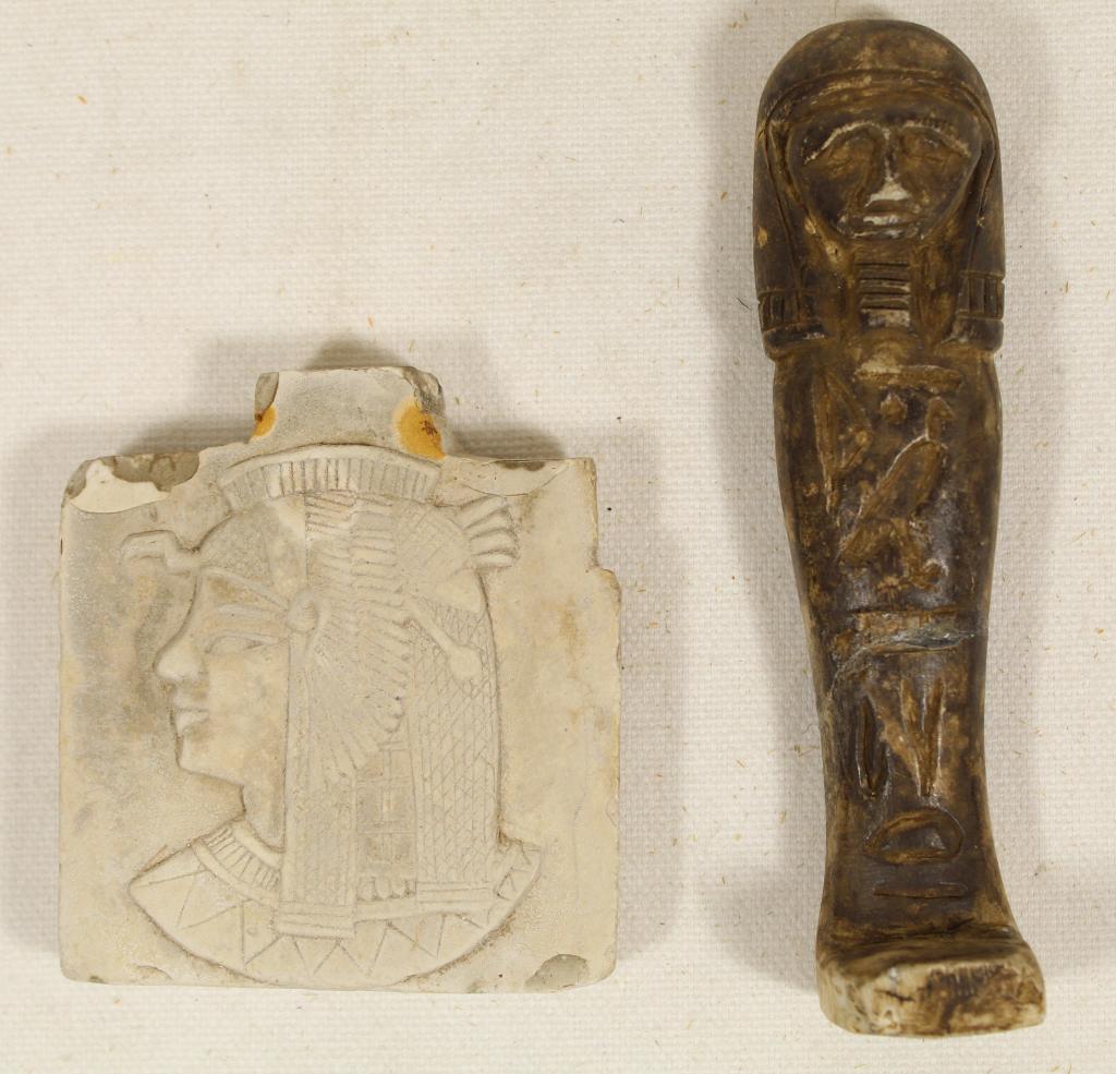Museum Reproduction Egyptian Plaque & Shabti: (1) Cast plaster plaque with head of Egyptian queen/ goddess. "Antiqued" surface. 2 3/4" x 2 1/2" x 1/2". (2) Cast tomb shabti figure with "antiqued" surface. Old glued break at legs. 4 3/8".