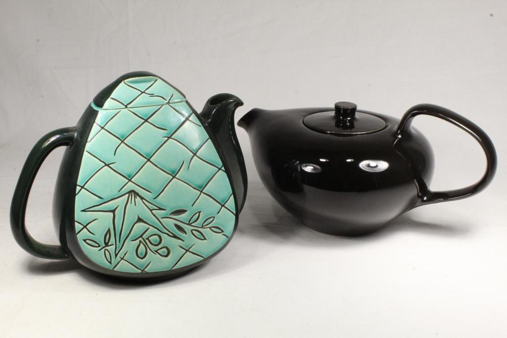 Mid Century Roselane & Russel Wright Teapots: (1) Roselane Pasadena stylized pineapple shaped #7 teapot in black and teal glaze. Marked to bottom. Small chip to underside rim of lid at corner. 7.5" H approx. (2) Black glaze reproduction Russel Wr