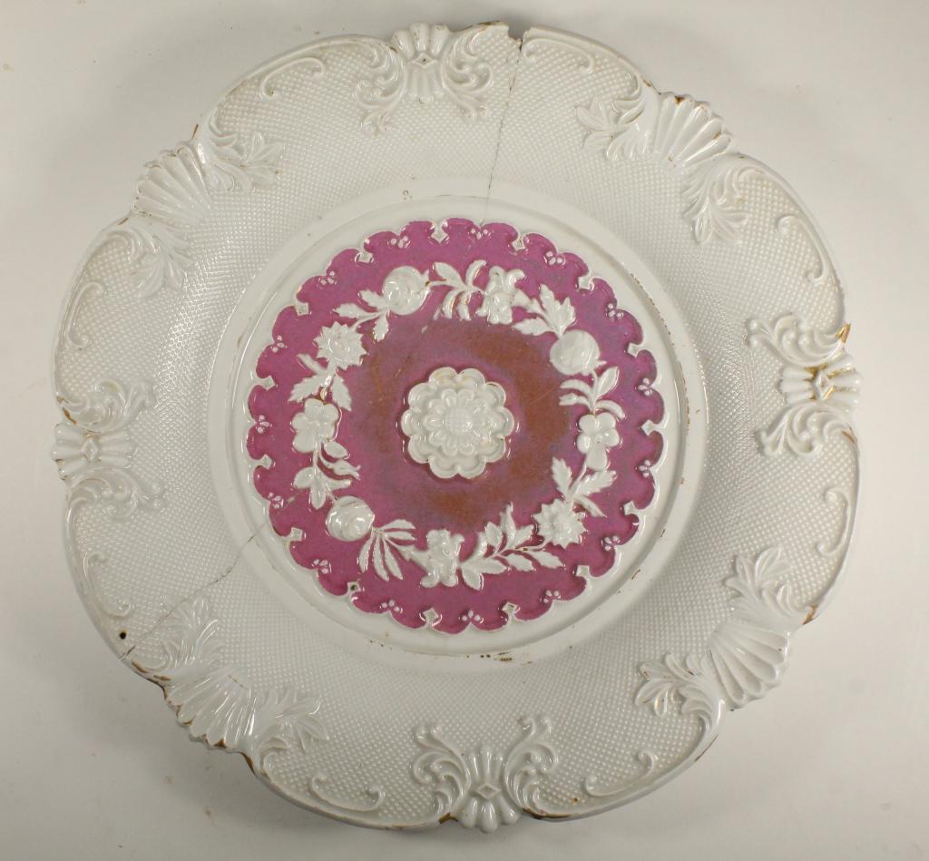 Antique Staple Repair Meissen Plate: Plate with raised floral designs in white and pinkish glazes. Blue under glaze crossed sword mark to the underside. Break repaired with 6 staples; other small chip losses, etc. 10.75" dia.