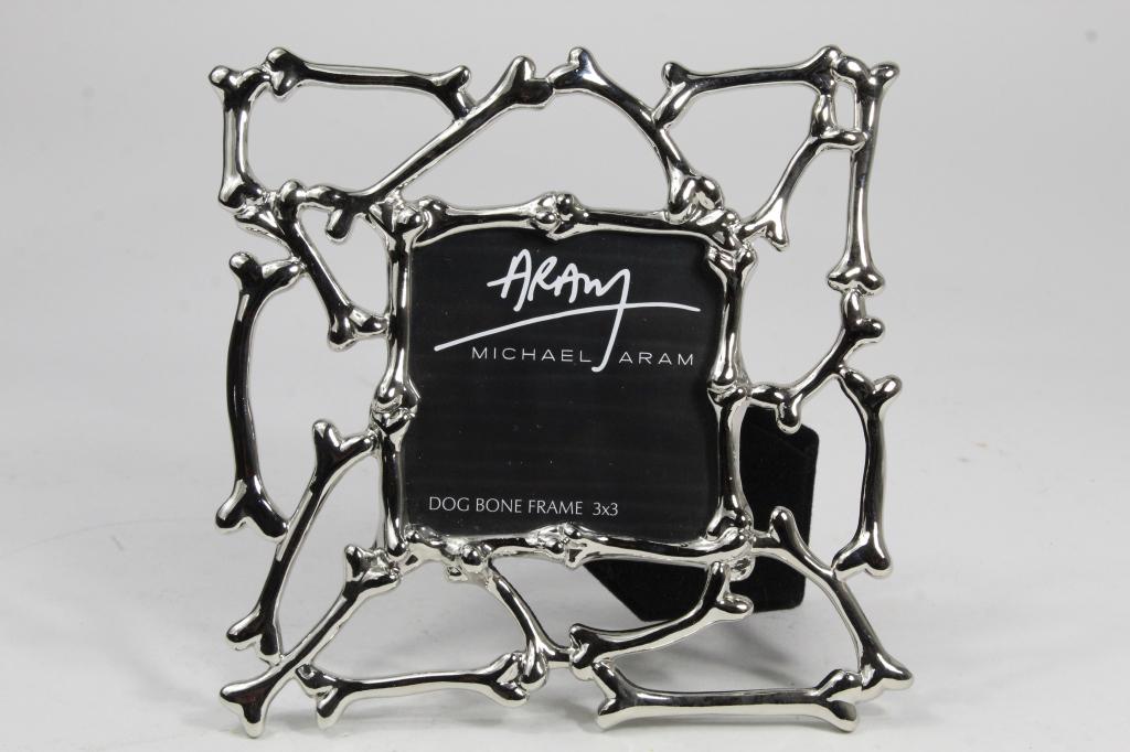 Michael Aram Dog Bone Frame: Silver plated metal with velvet backing. Excellent condition. Frame 6.5" x 6.5" with 3" x 3" opening.