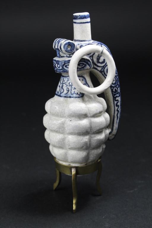 Charles Krafft (1947-2020) Spone Delft Grenade: Hand decorated Delft style (with Arabic characters) "Spone" ceramic with metal cotter pin. Signed to base: CWK SPONE 2005. Excellent condition with no chips, cracks, or apparent repairs. 5.25" H. Incl