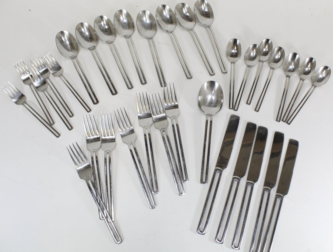 Towle NORDIC Stainless Flatware: Includes 5 salad forks, 7 dinner forks, 5 dinner knives, 8 tablespoons, 7 teaspoons, and 1 serving spoon. All stamped TOWLE 18/10 CHINA. Good condition; surface signs of use.