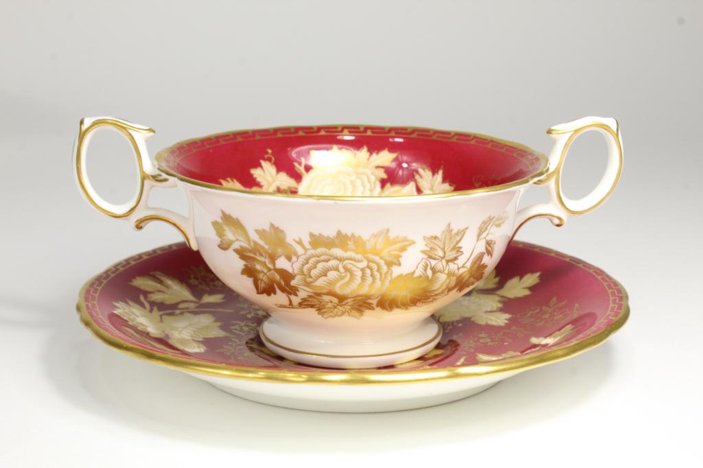 Wedgwood TONQUIN RUBY Cream Soup Bowls & Saucers: 5 Tonquin Ruby pattern bone china double handled cream soup bowls with brown marks and 7 saucers (6 with brown marks and 1 with green mark). Very good condition with some light signs of use; no gold w